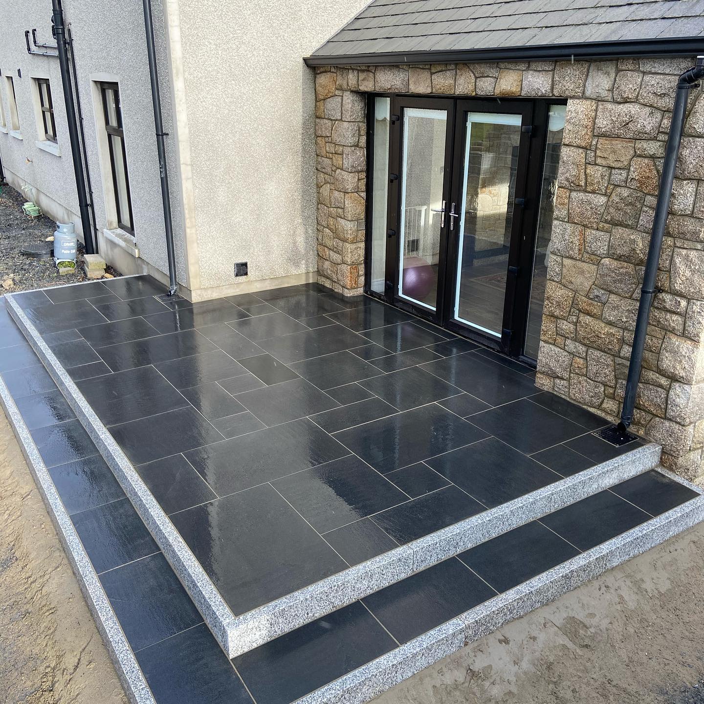 Modern tiled steps leading into the house